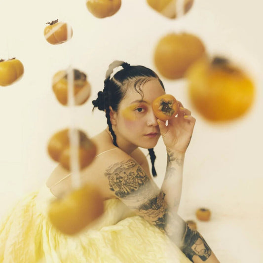 the album cover for Japanese Breakfast - Jubilee - Yellow & Black Swirl Colored Vinyl