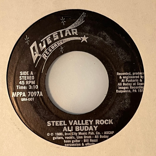 Ali Buday - Steel Valley Rock / (Everybody Wants) A Piece Of The Action 7"